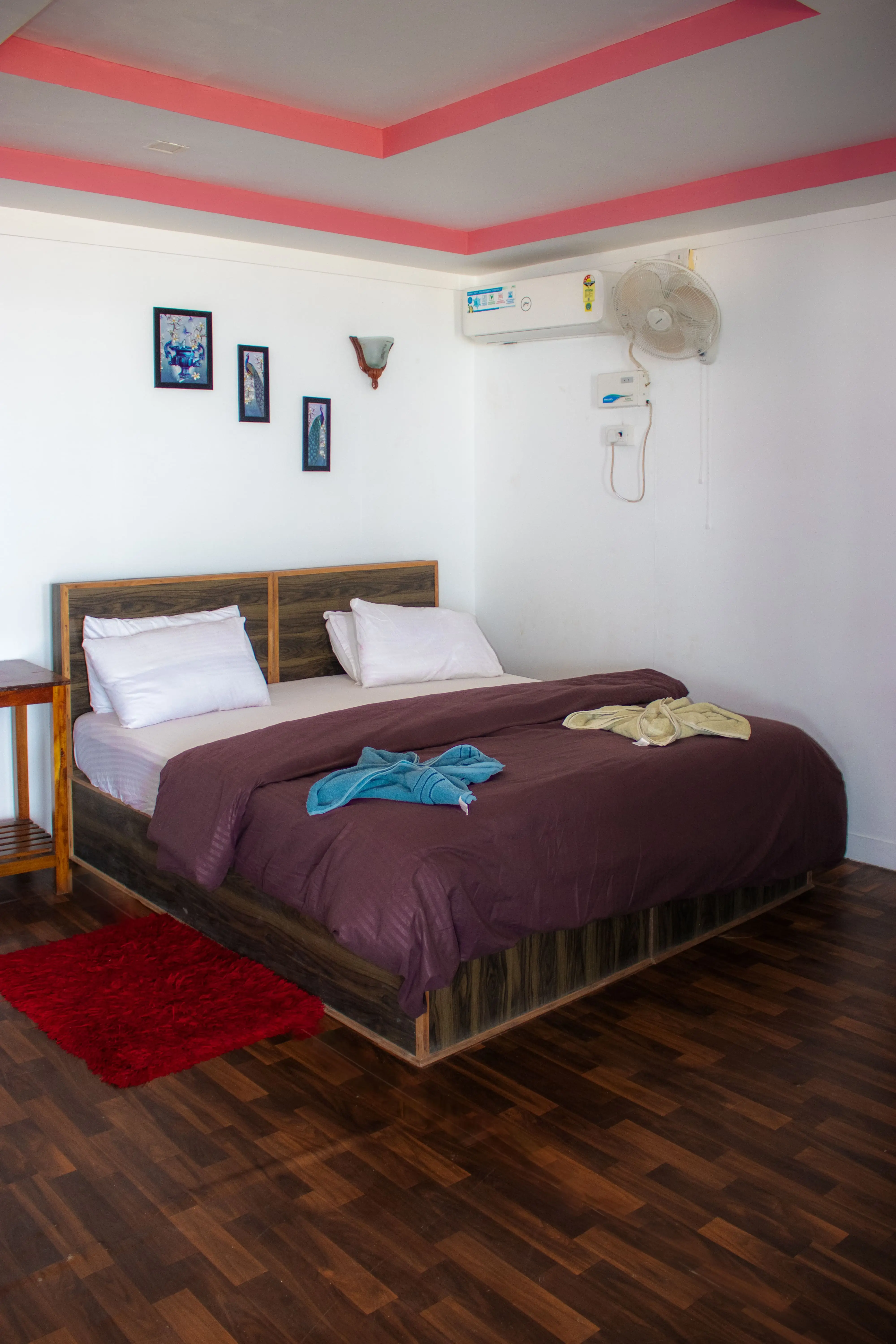 A neatly made bed in a cozy room, featuring soft linens and a warm ambiance