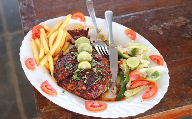 A dish presenting a delicious fish fillet paired with crispy French fries, showcasing a classic and appetizing meal.