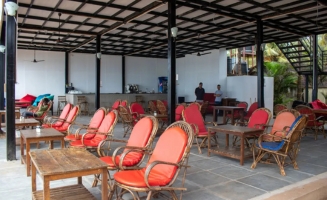 A spacious restaurant featuring numerous chairs and tables arranged for dining.